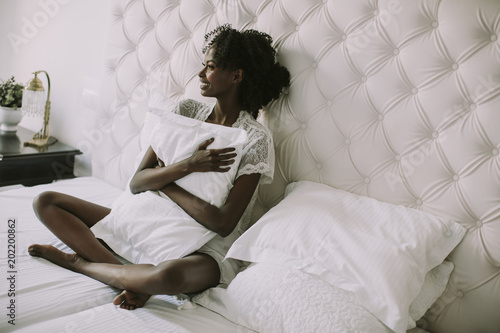 Young black woman in bed