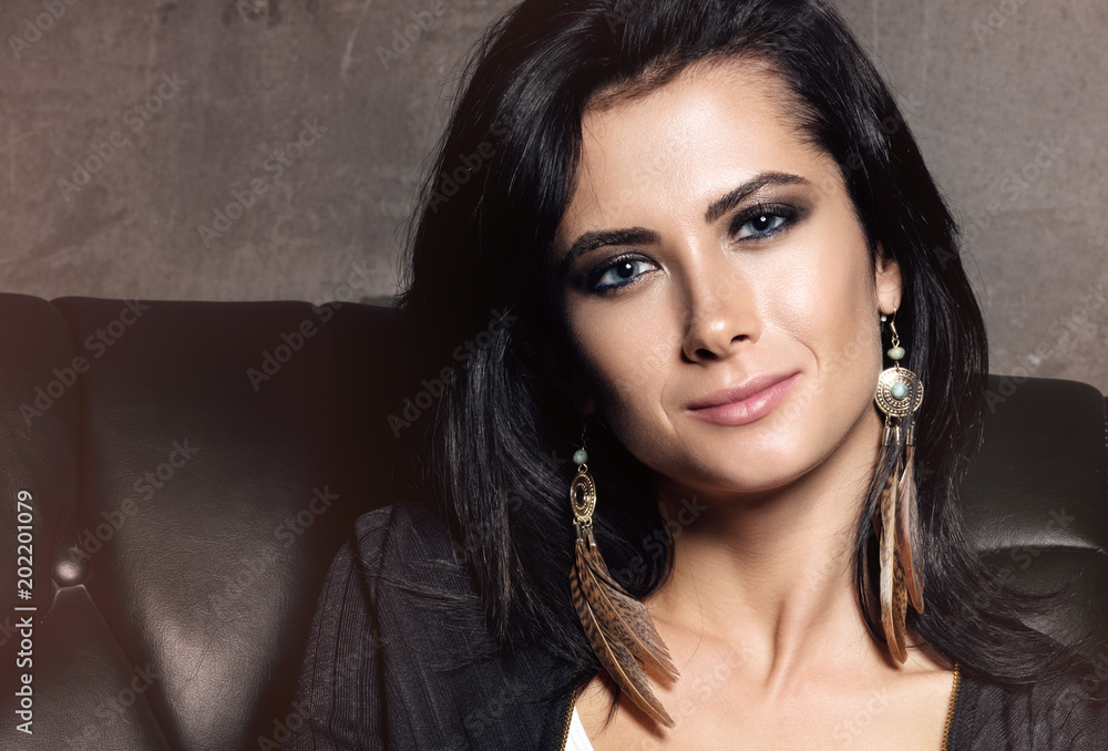 Fashion closeup portrait of beautiful young woman with light makeup and black hair