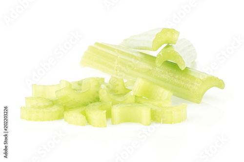 Three fresh green celery sticks and chopped sliced pieces stack isolated on white background. photo