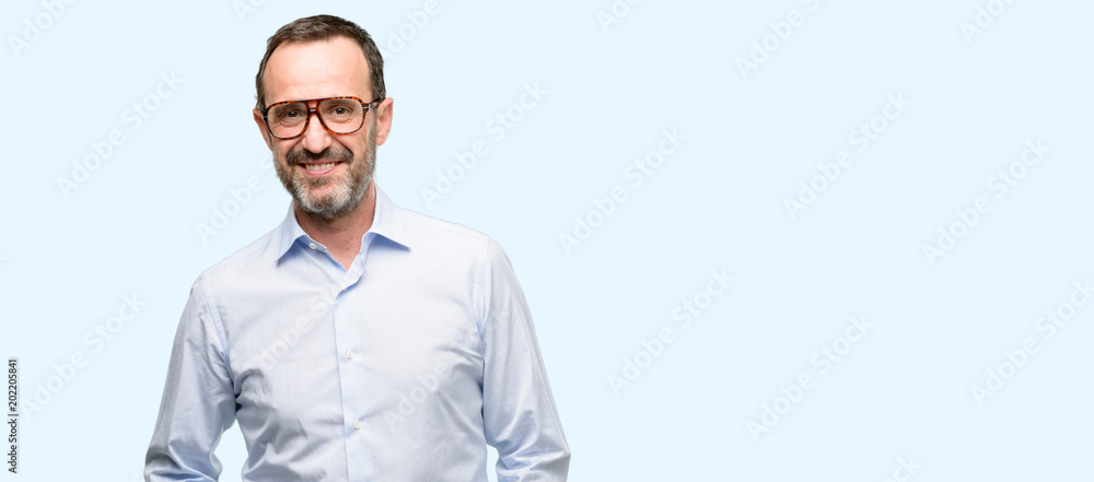 Middle age man with glasses confident and happy with a big natural smile laughing isolated over blue background Middle age man with glasses confident and happy with a big natural smile laughing isolated over blue background