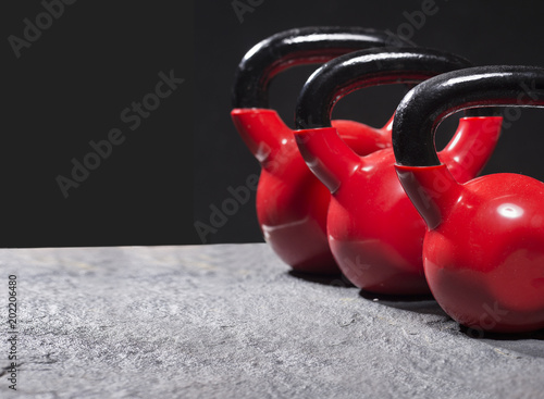 Fototapeta Naklejka Na Ścianę i Meble -  red kettlebells on roug surface