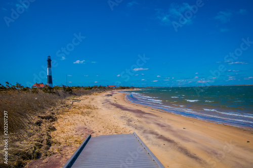 Outdoor view of Atlantic ocean waves on the beach at Montauk Point Light, Lighthouse, located in Long Island, New York, Suffolk County photo