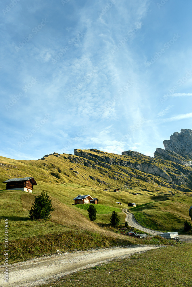 beautiful mountain landscape with wooden house in summer time in Dolomites Apl