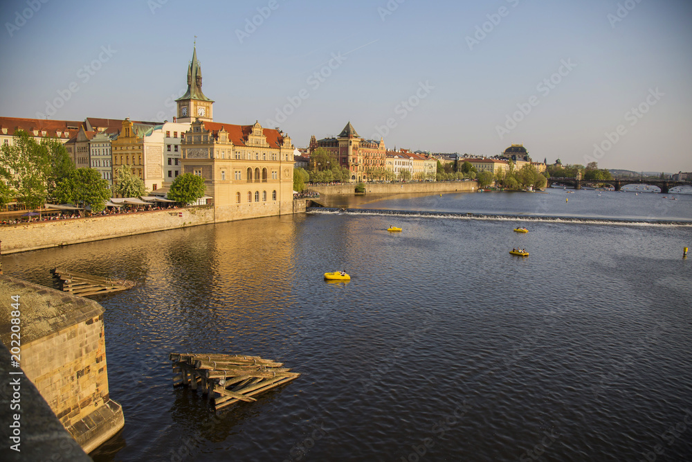 Vltava river in spring Prague, with many of turistic boats, view from Charles bridge