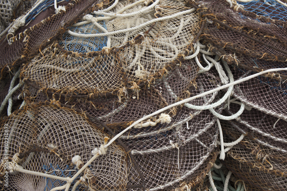 Vintage background - fishing nets for marine concept about craft of  fishermen in retro style. Sea nets - fishing equipment or tackle as texture  with cross-process effect. Stock Photo