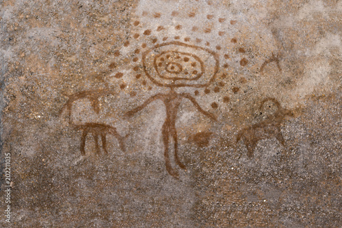 An ancient image of man and animals on the wall of the cave. era. ancient history. archeology