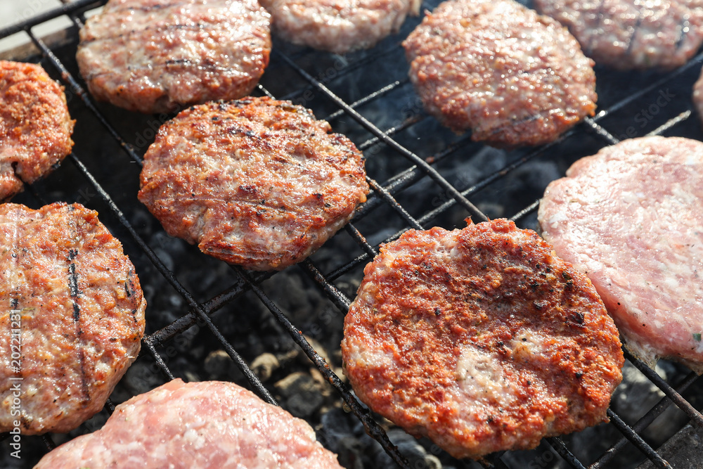 Fresh meat patties for burgers on the grill Fresh meat patties for burgers on the grill