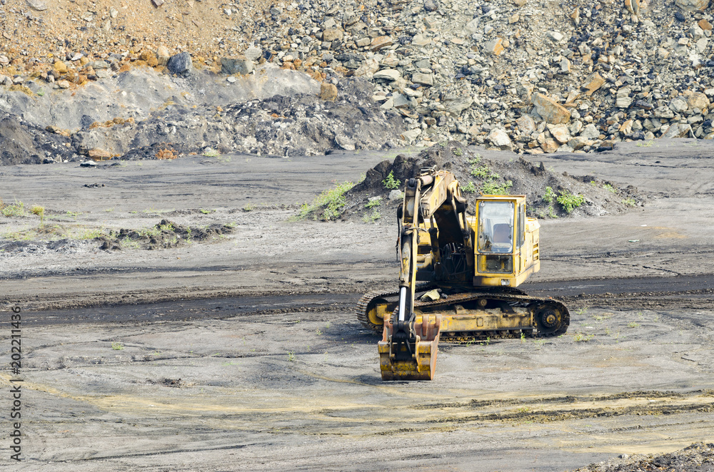 a digger in a limestone quarry a digger in a limestone quarry