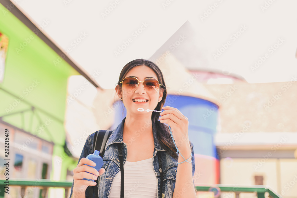 Fototapeta premium Beautiful girl is playing soap bubble fun.