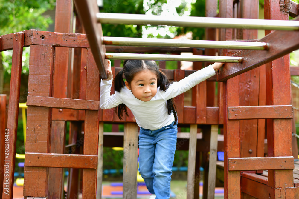 The girl is playing in the park. The girl is playing in the park.