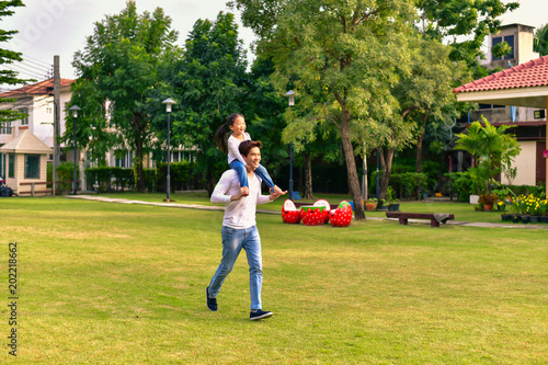 Parents and daughters go for a walk in the park.