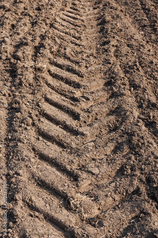 detail view of tracks of tractor tires on a field detail view of tracks of tractor tires on a field