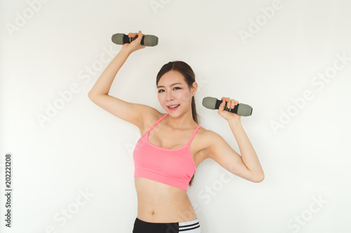 Sports concept. Beautiful girl is exercising in the home with warm up. Beautiful girl is happy to exercise.Beautiful women playing sports for health. © S photographer