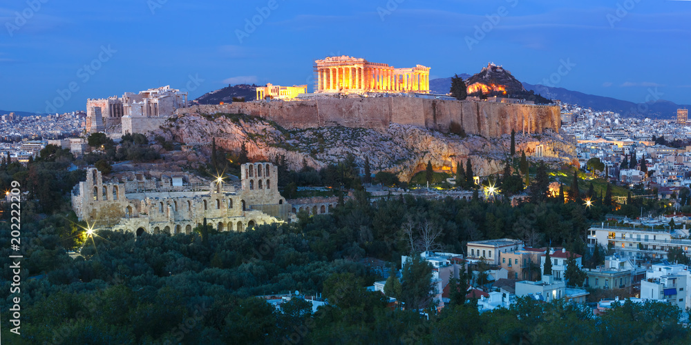 Panoramic aerial view of the Acropolis Hill, crowned with Parthenon during evening blue hour in Athens, Greece