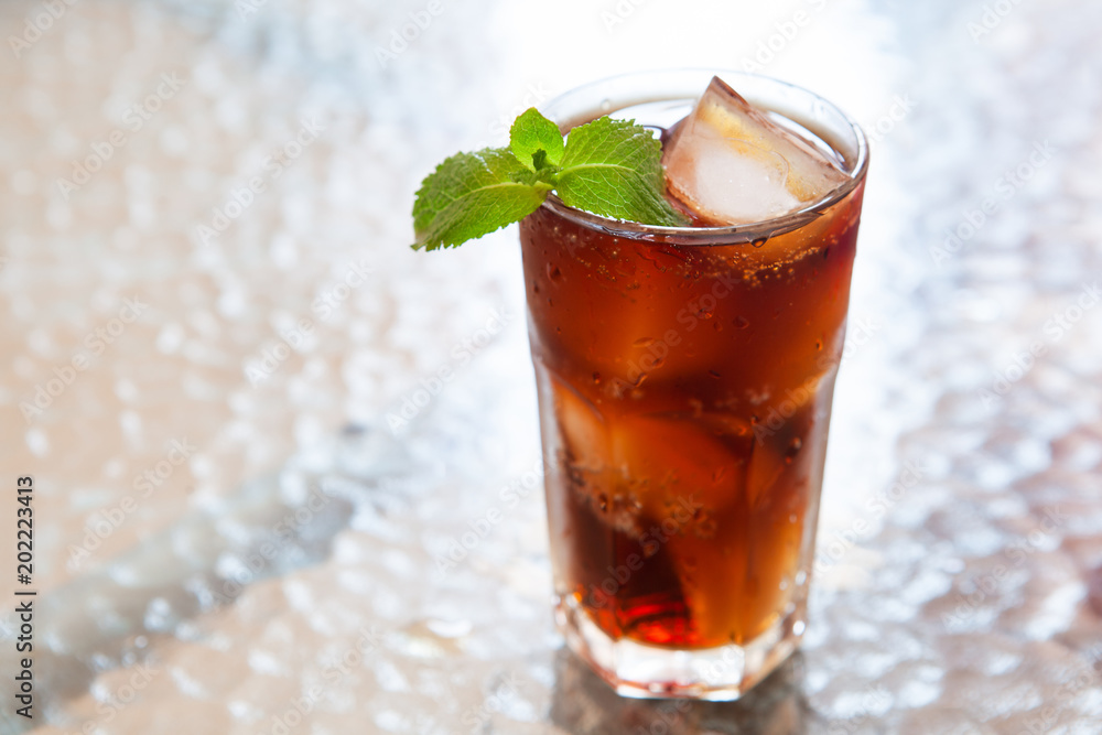 Cold summer drink in glass with ice and mint on the table Cold summer drink in glass with ice and mint on the table