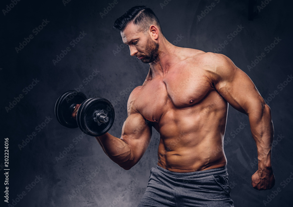 Portrait of a shirtless tall huge male with a muscular body with a stylish  haircut and beard, in a sports shorts, standing in a studio. Stock Photo |  Adobe Stock