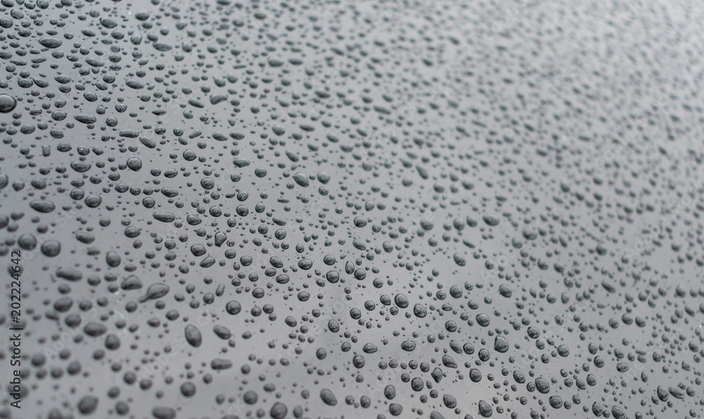 Water drops on a dark silver surface. Water drops on a dark silver surface.