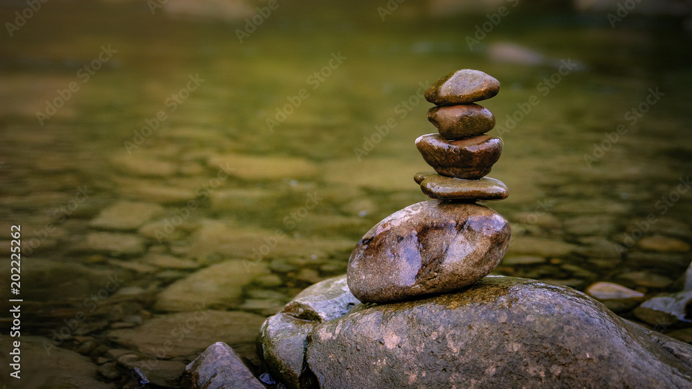 Balance of stones on the bank of a mountain river. The Prut river, Yaremche city, Ukraine.