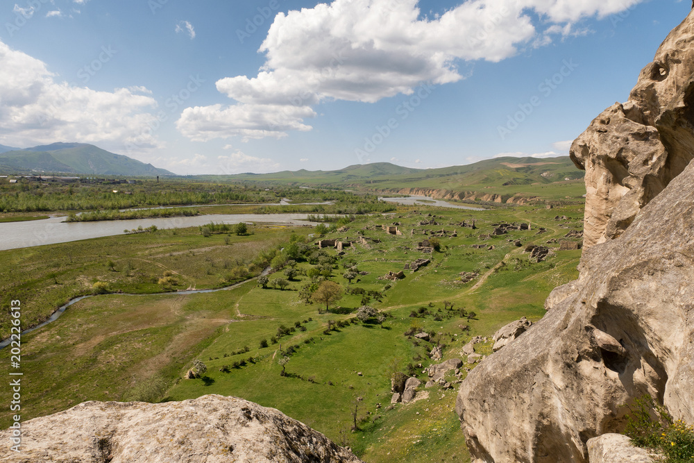 Cave town Uplistsikhe Georgia. Scenic view from above on valley with fragments of ruins. Cave town Uplistsikhe Georgia. Scenic view from above on valley with fragments of ruins.
