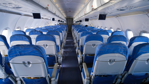 Empty aircraft cabin during flight. Blue salon.