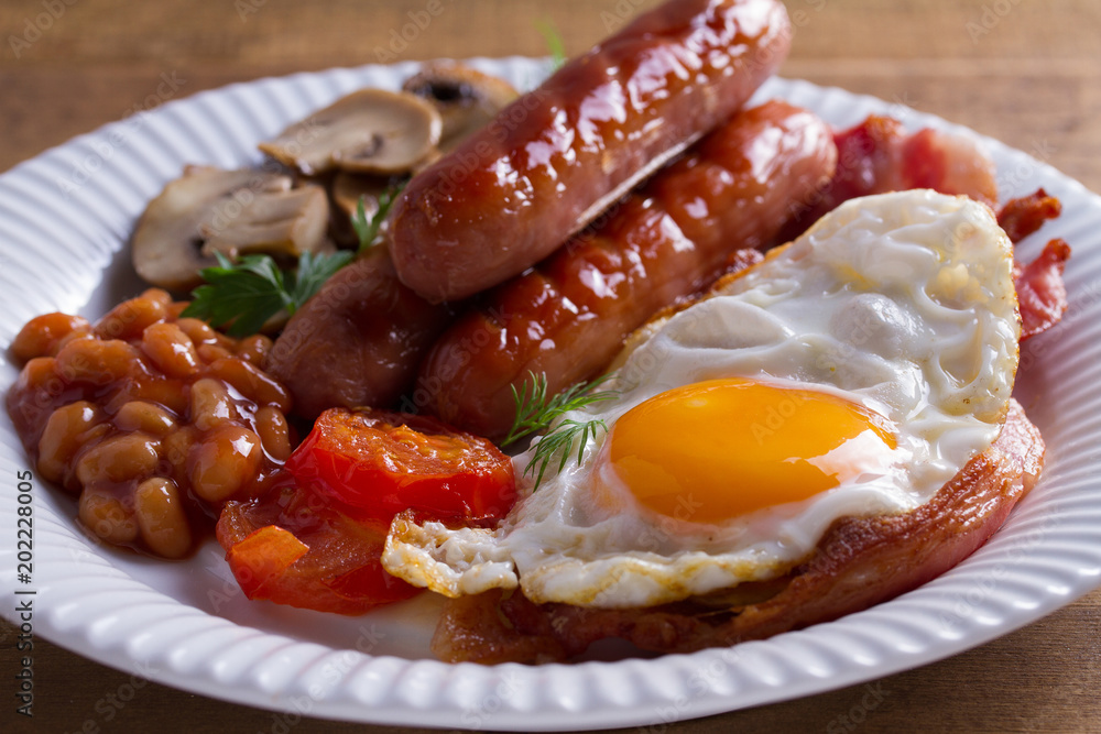 Full English or Irish breakfast: sausages, bacon, egg, mushrooms, tomatoes and beans. Nutritious morning meal Full English or Irish breakfast: sausages, bacon, egg, mushrooms, tomatoes and beans. Nutritious morning meal
