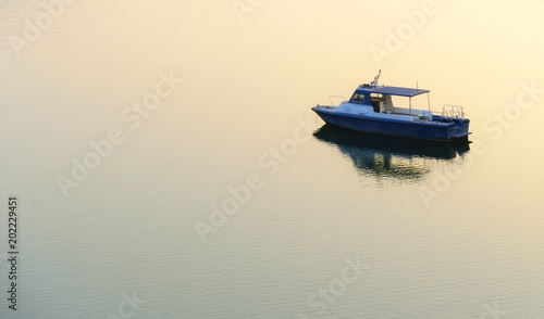 Boat blue color floating in water,top view