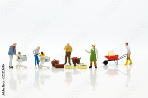 Miniature people : Spending cash for shopping in the market. Image use for marketing, merchant middleman,retail business concept.