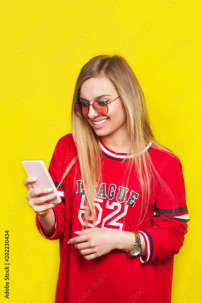 Fashion pretty young woman model in sunglasses using smartphone Fashion pretty young woman model in sunglasses using smartphone