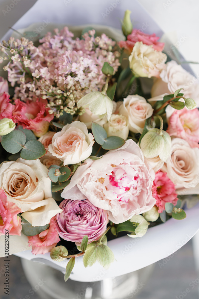 bouquet of beautiful flowers with peony on gray table. Floristry concept. Spring colors. the work of the florist at a flower shop. Vertical photo bouquet of beautiful flowers with peony on gray table. Floristry concept. Spring colors. the work of the florist at a flower shop. Vertical photo