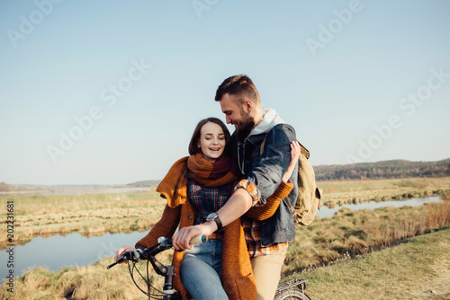 couple in love on a bike on nature in autumn
