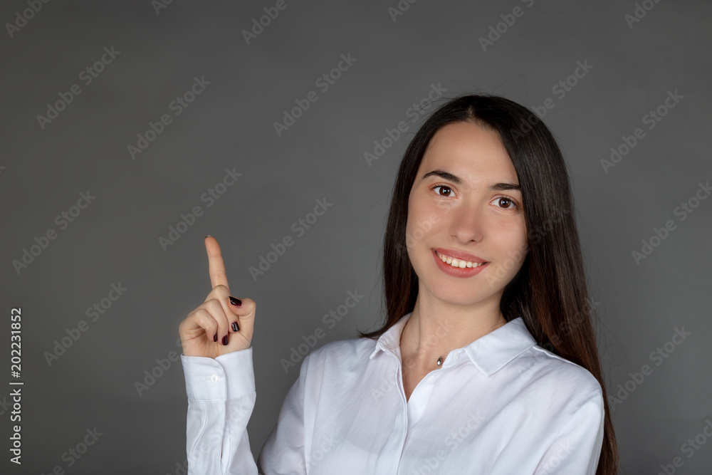 Beautiful smiling Turkish girl signing the upside with her hand Beautiful smiling Turkish girl signing the upside with her hand