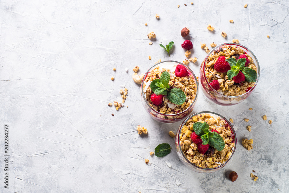 Yogurt parfafait with granola and raspberries top view. Yogurt parfafait with granola and raspberries top view.