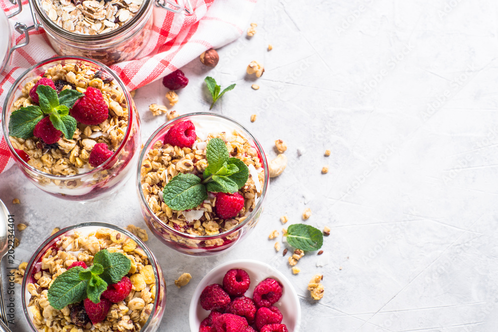 Yogurt parfafait with granola and raspberries top view. Yogurt parfafait with granola and raspberries top view.