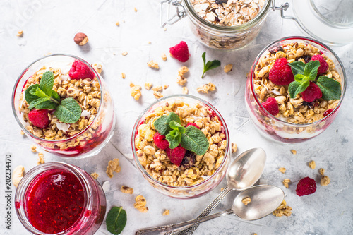 Yogurt parfafait with granola and raspberries top view. photo