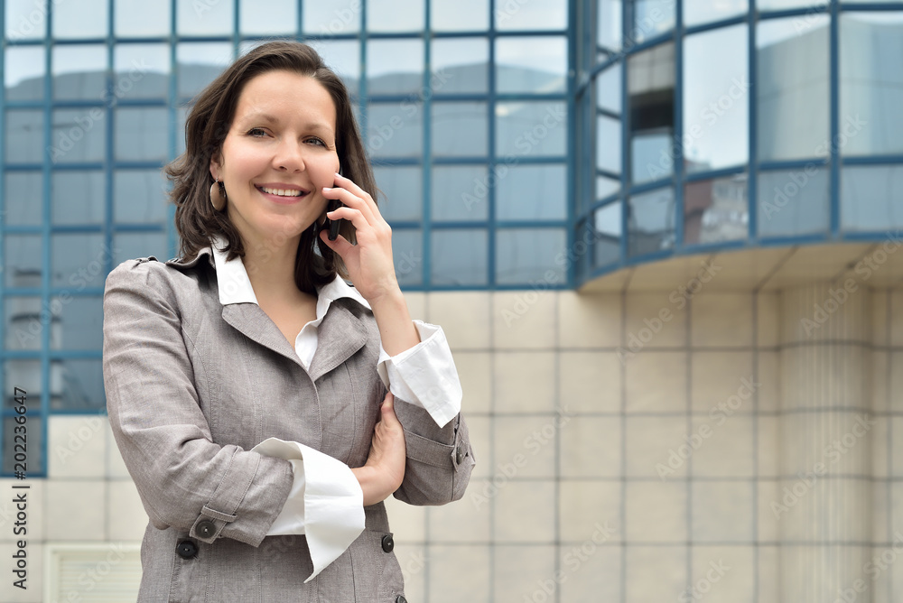 Smiling businesswoman talking on the smartphone Smiling businesswoman talking on the smartphone