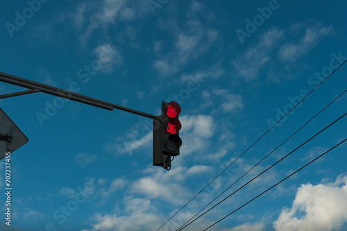 Red traffic light with timer. Against the sky. Countdown Traffic Light.