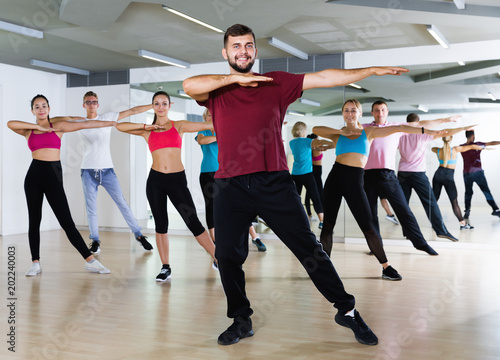 Group of active young people dancing