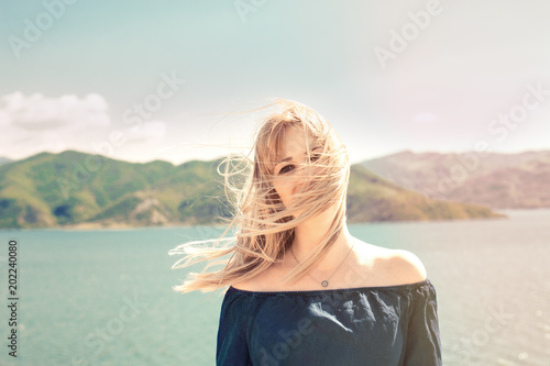Portrait of beautiful woman beside a lake