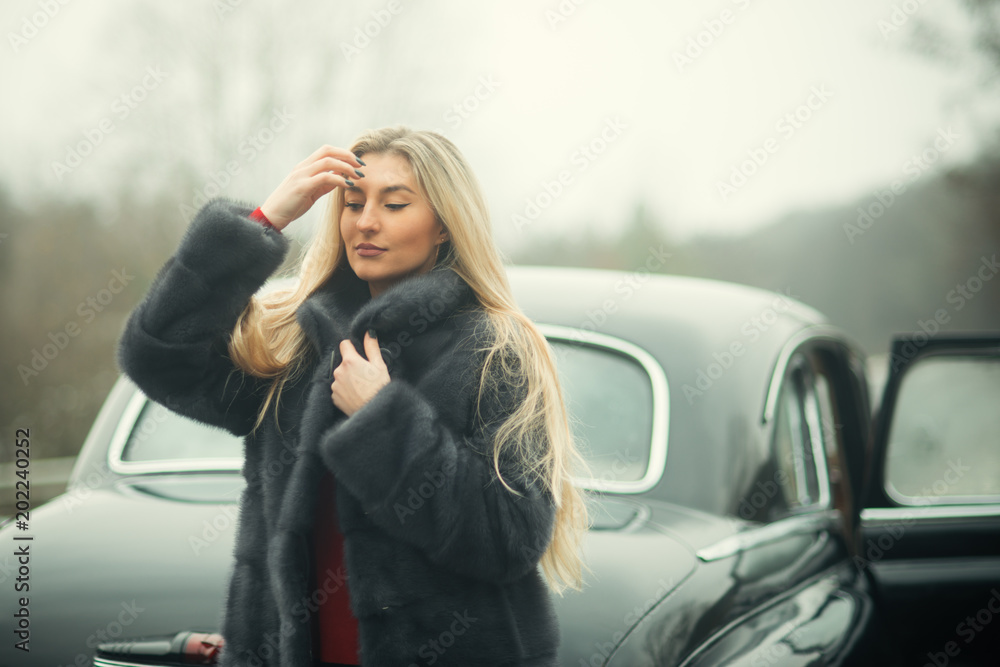 Flirty and glamorous woman with black retro car. Flirty and glamorous woman with black retro car.