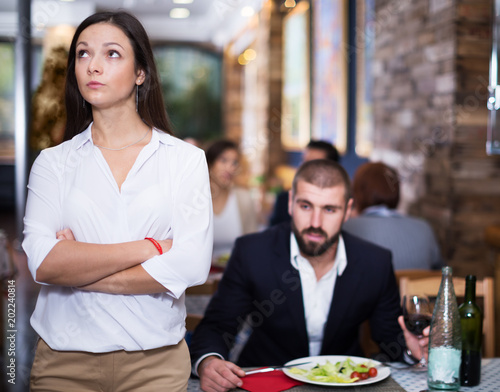 Quarreled visitors female and male in restaurant