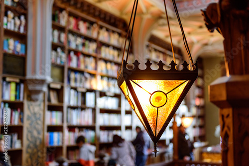 Decorative lantern with blurred bookshelf and unrecognisable people in the background