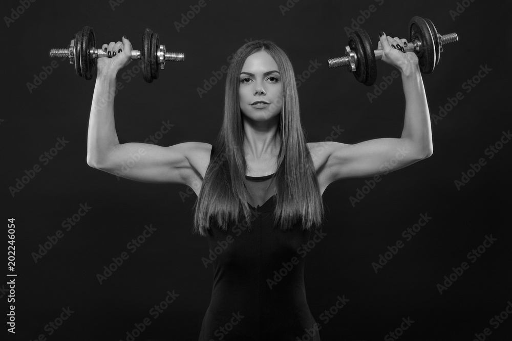 fitness woman in doing exercises with dumbells. fitness woman in doing exercises with dumbells.