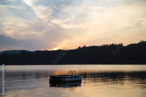 Metal swim platform, Squam Lake, New Hampshire, at sunset
