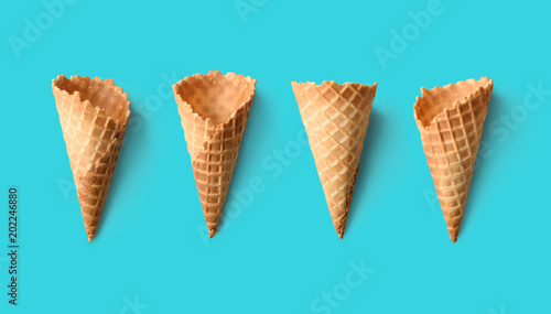 Collection of empty ice cream cones on retro color background