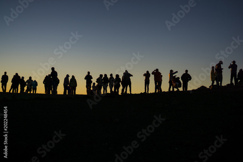 silhouette of photographers waiting for the sun to set