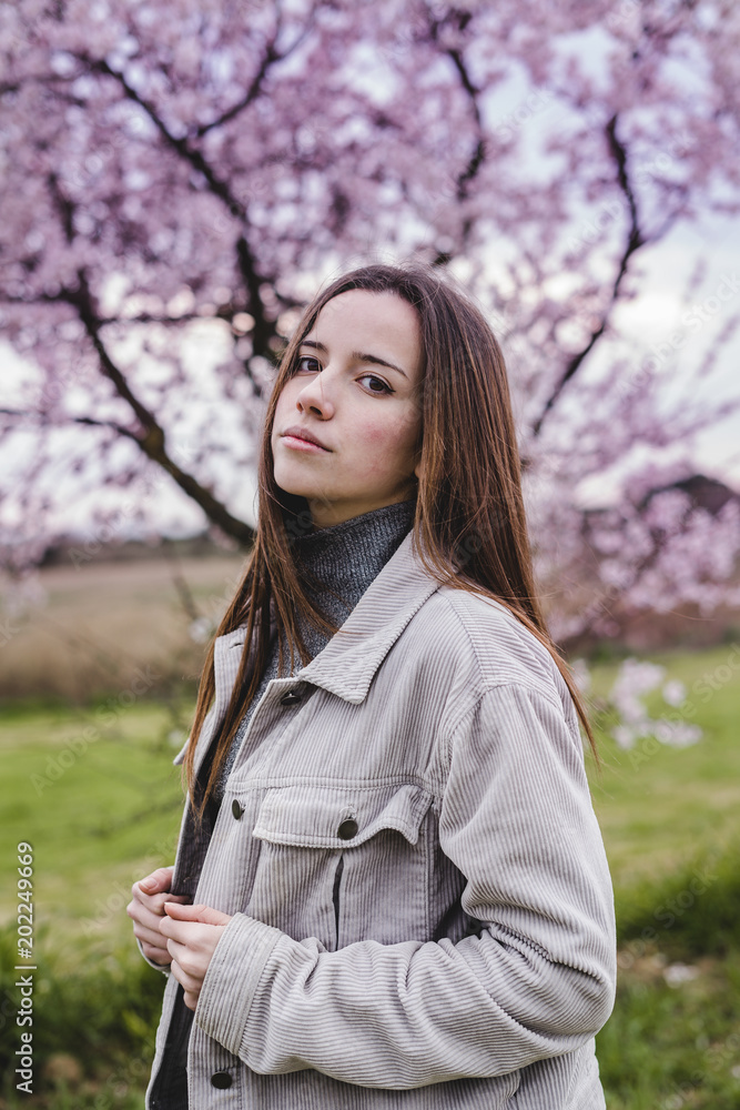 Young girl surrounded by pink trees Young girl surrounded by pink trees
