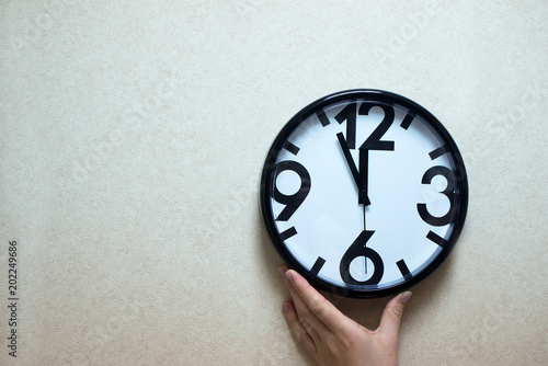Large white clock with arrows.