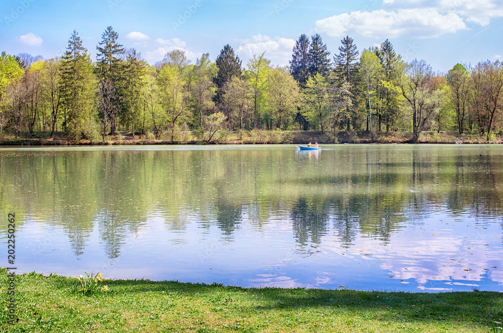 
Idyllic park with a lake.
Spring time in Munich, Germany. Small boat in a lake near Isar river.