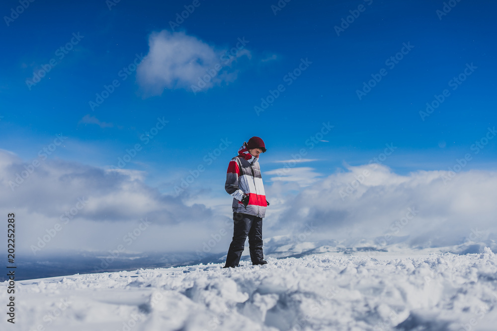 Young boy exploring the snowy landscape