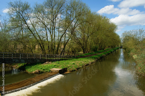 River, channel and wooden bridge. Countryside landscape © aljona9